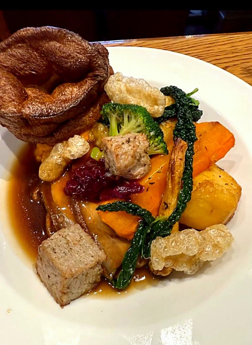 Sunday roast dinner with Yorkshire pudding, roast vegetables and gravy